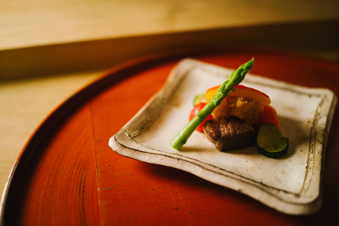 Wagyu beef with cherry tomatoes, bell pepper, white radish and zucchini topped with baby asparagus.